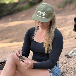 Woman wearing a green mod archery rope hat
