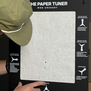 an archer checks the tear from shooting through their paper tuner bow tuning system