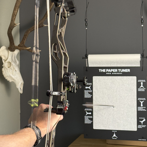 an archer shooting through the paper tuner bow tuning system 