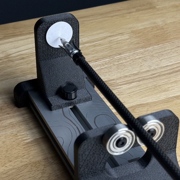 mod archery tabletop spinner shown to test if broadhead wobbles
